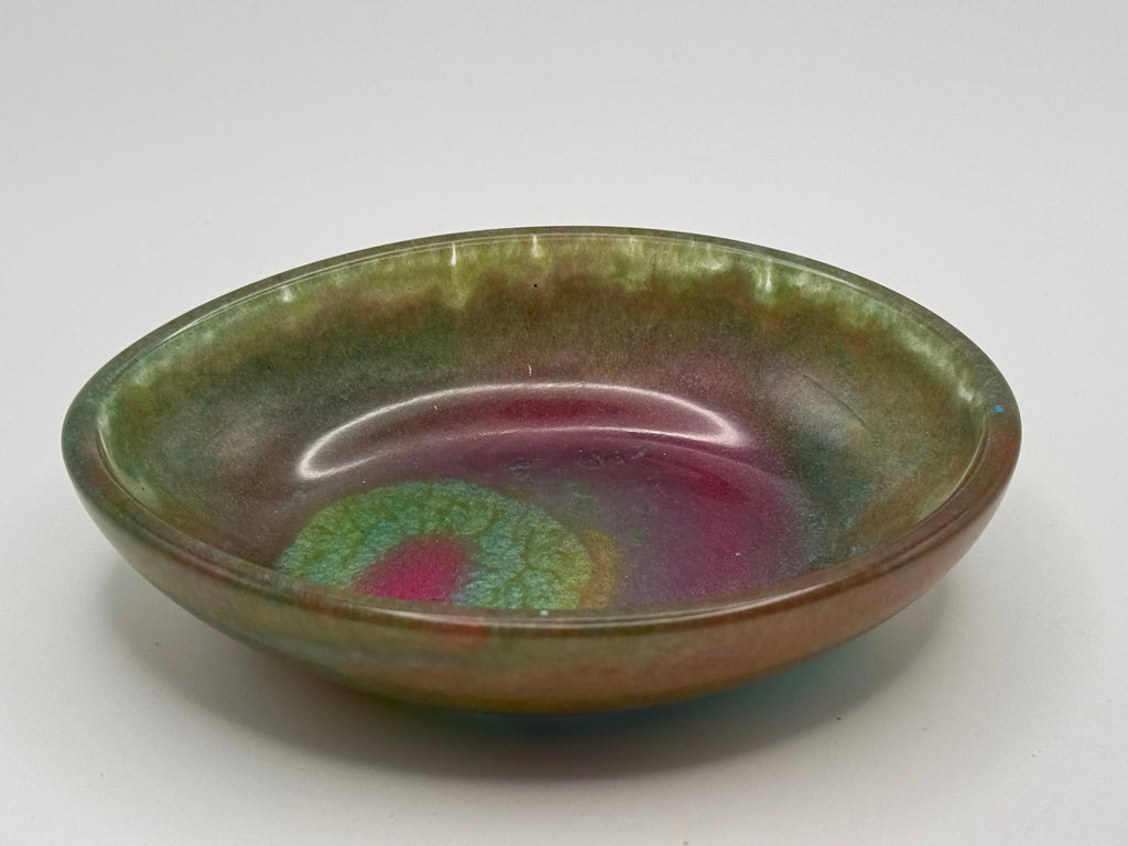 Resin dish with green and pink glaze on a white background
