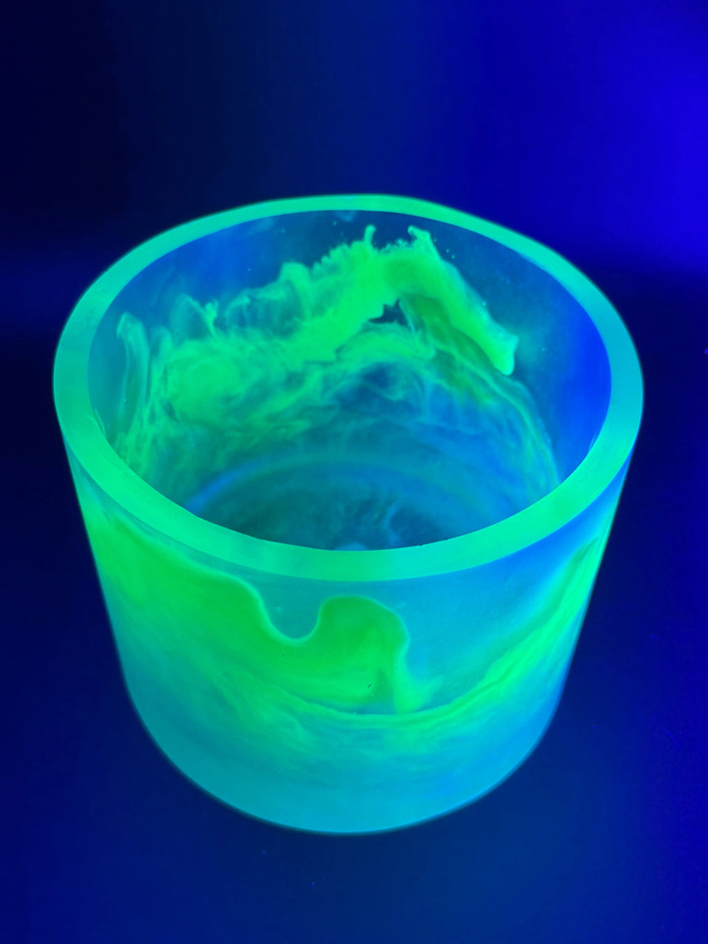 Glowing green container with a detailed interior design on a dark blue background