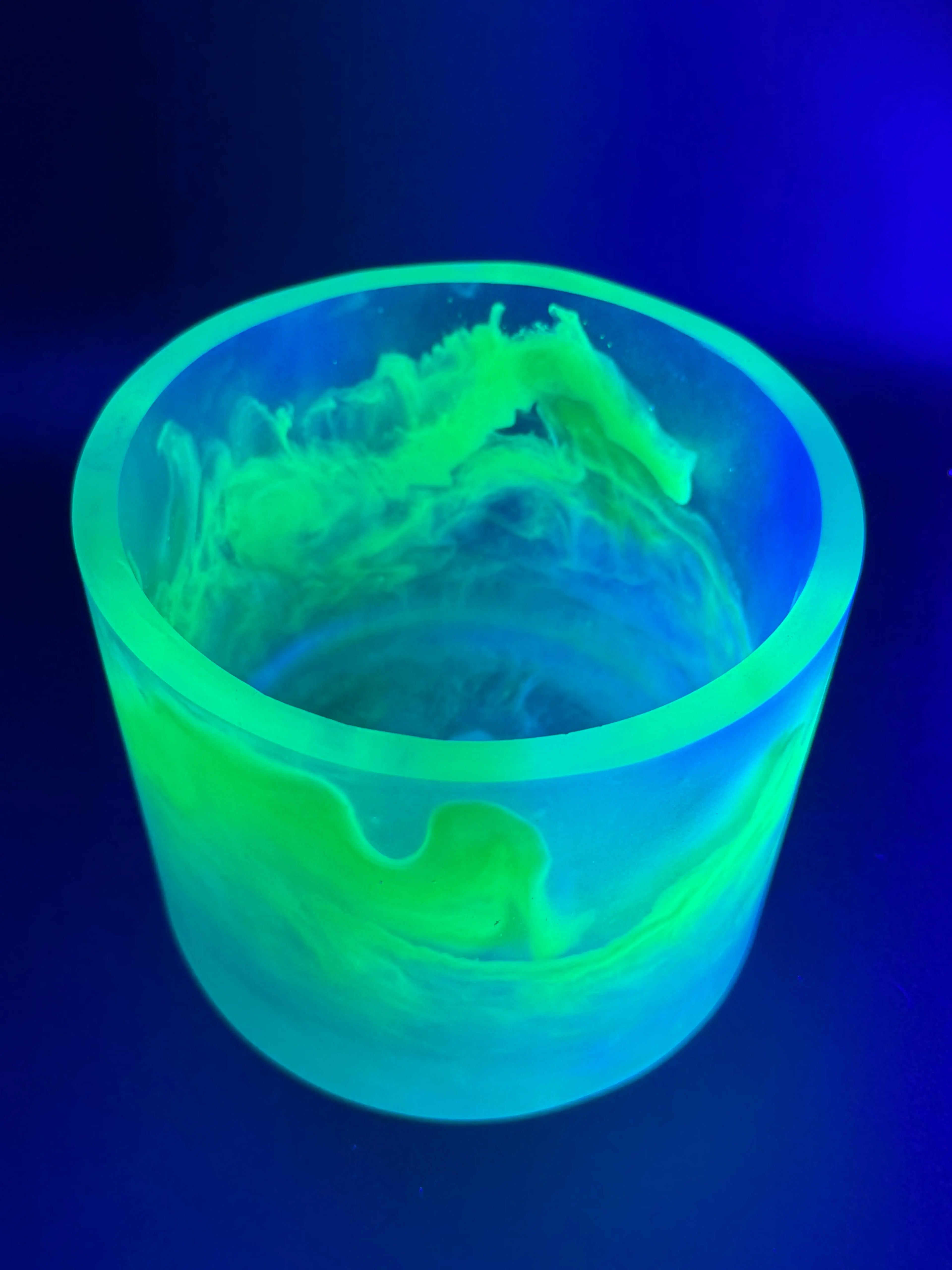 Glowing green container with a detailed interior design on a dark blue background