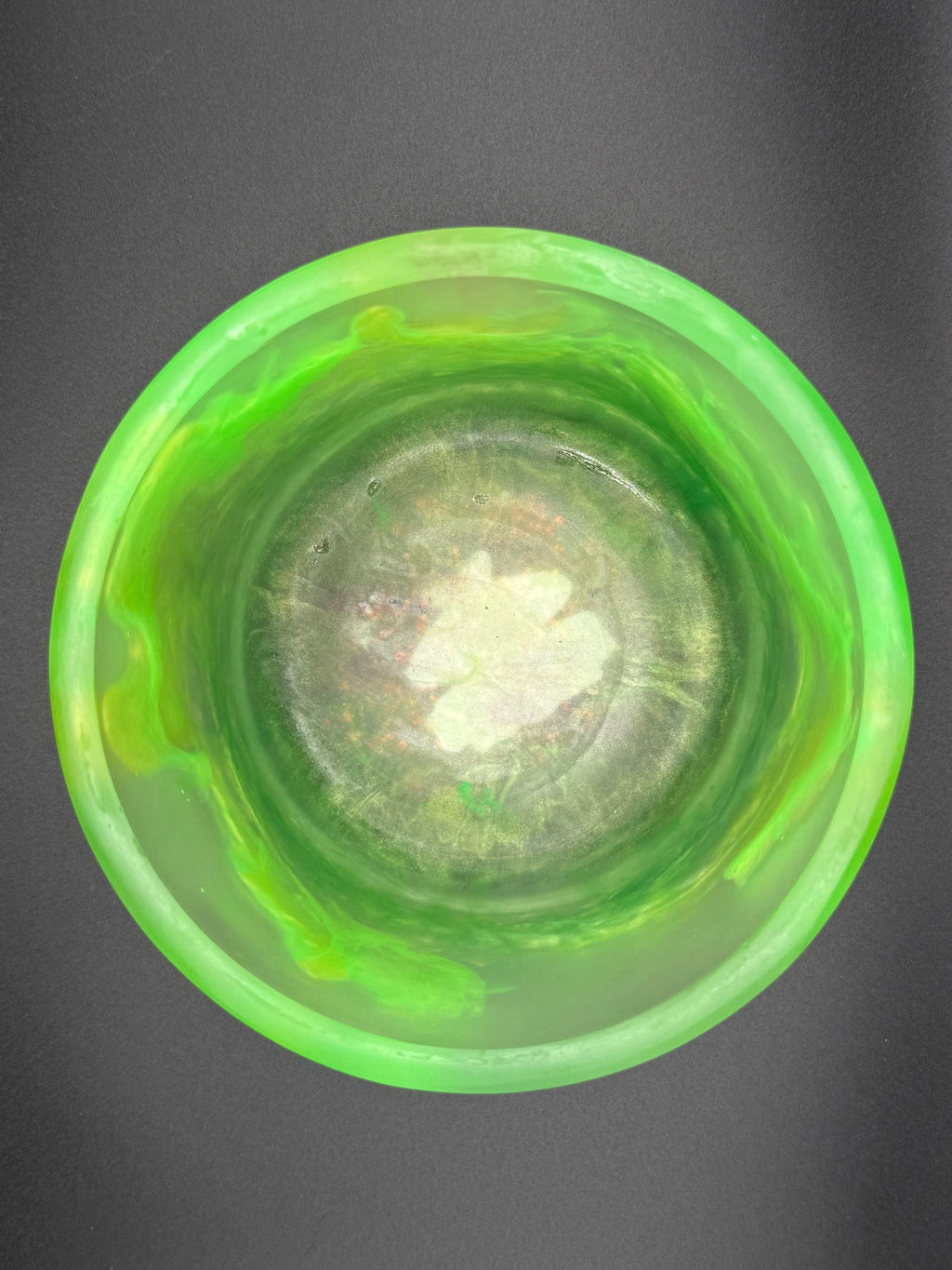 Green glass bowl on a dark gray background