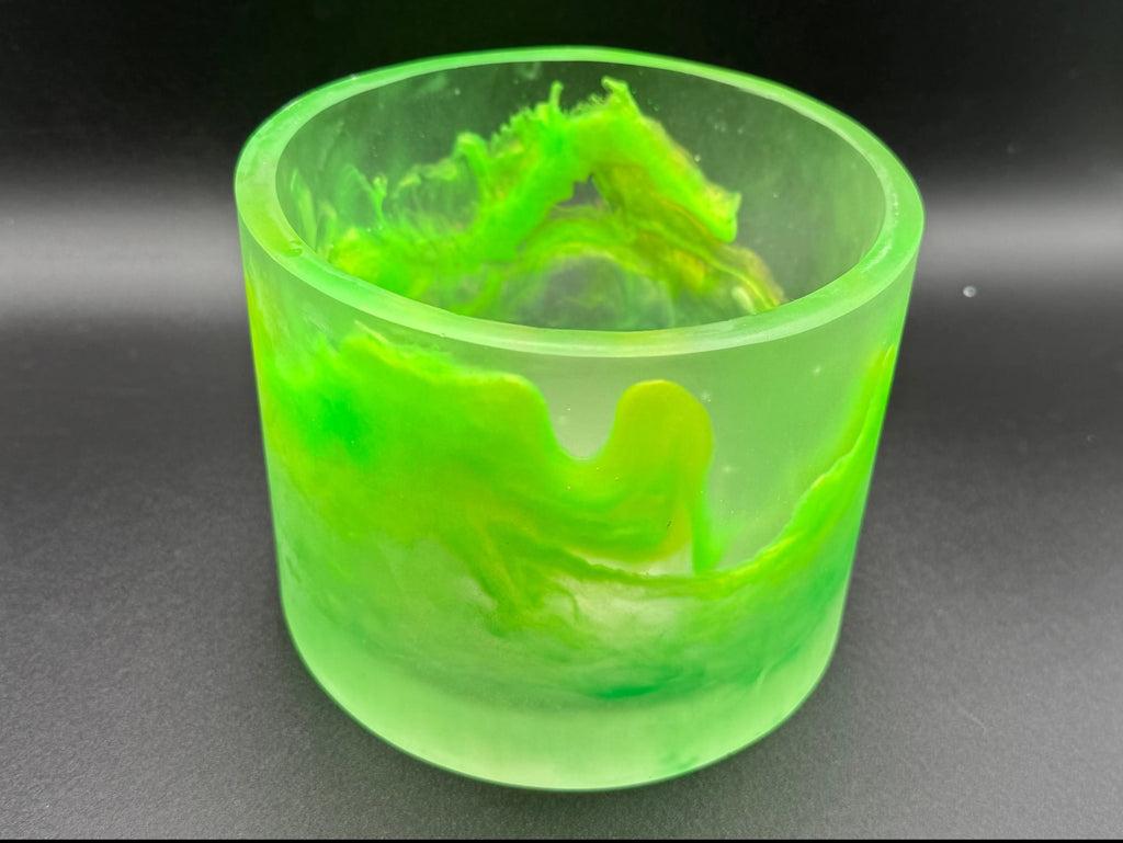 Green translucent bowl with a textured interior on a dark background