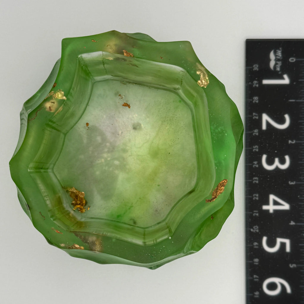 Geometric green, gold, and copper leaf bowl with a ruler for scale showing 5.5 inches, octagon on a white background