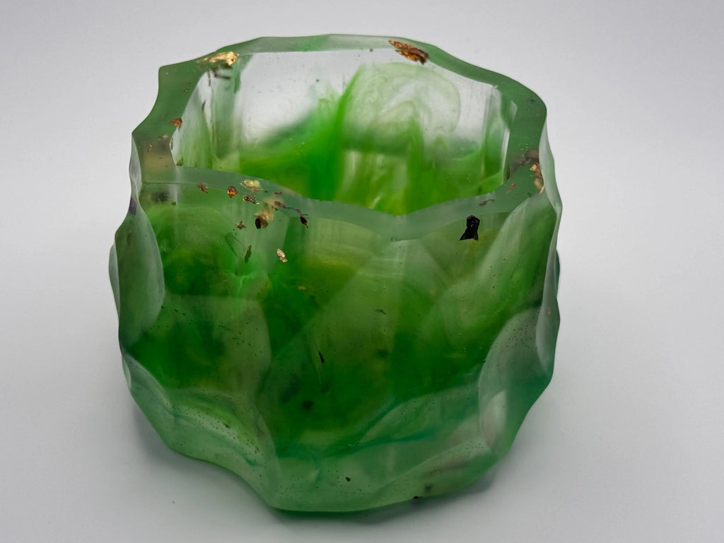 Geometric green resin bowl with  gold and copper leaf on a white background