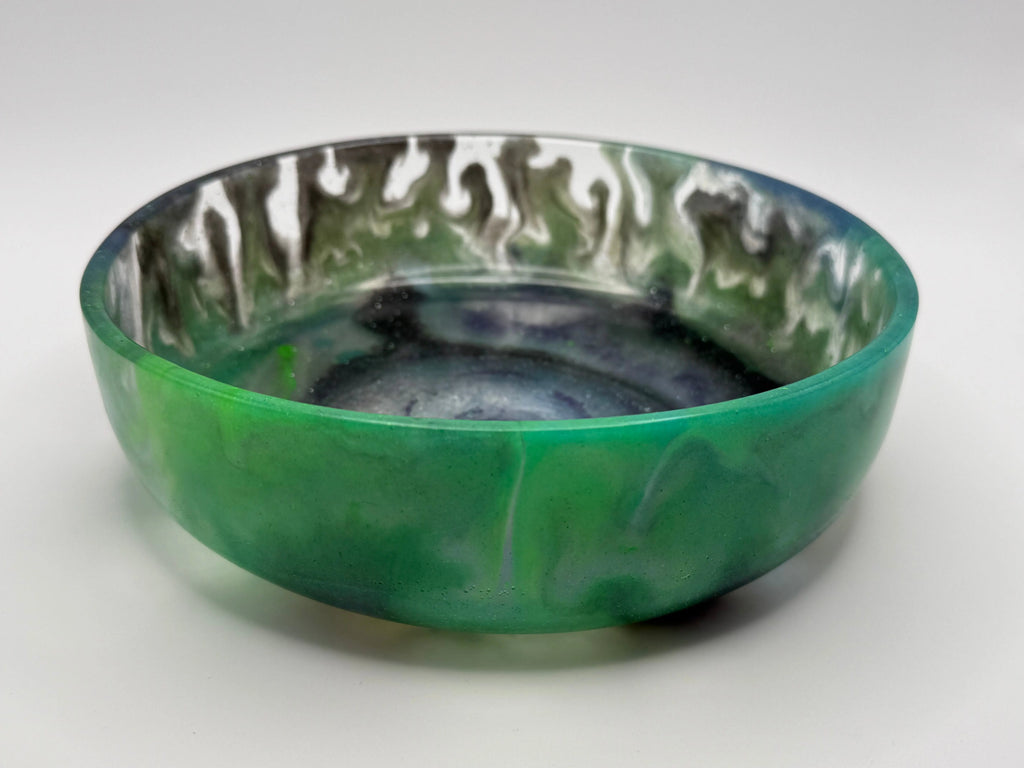 Abstract green and black resin dish on white background