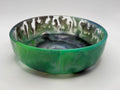 Abstract green and black resin dish on white background
