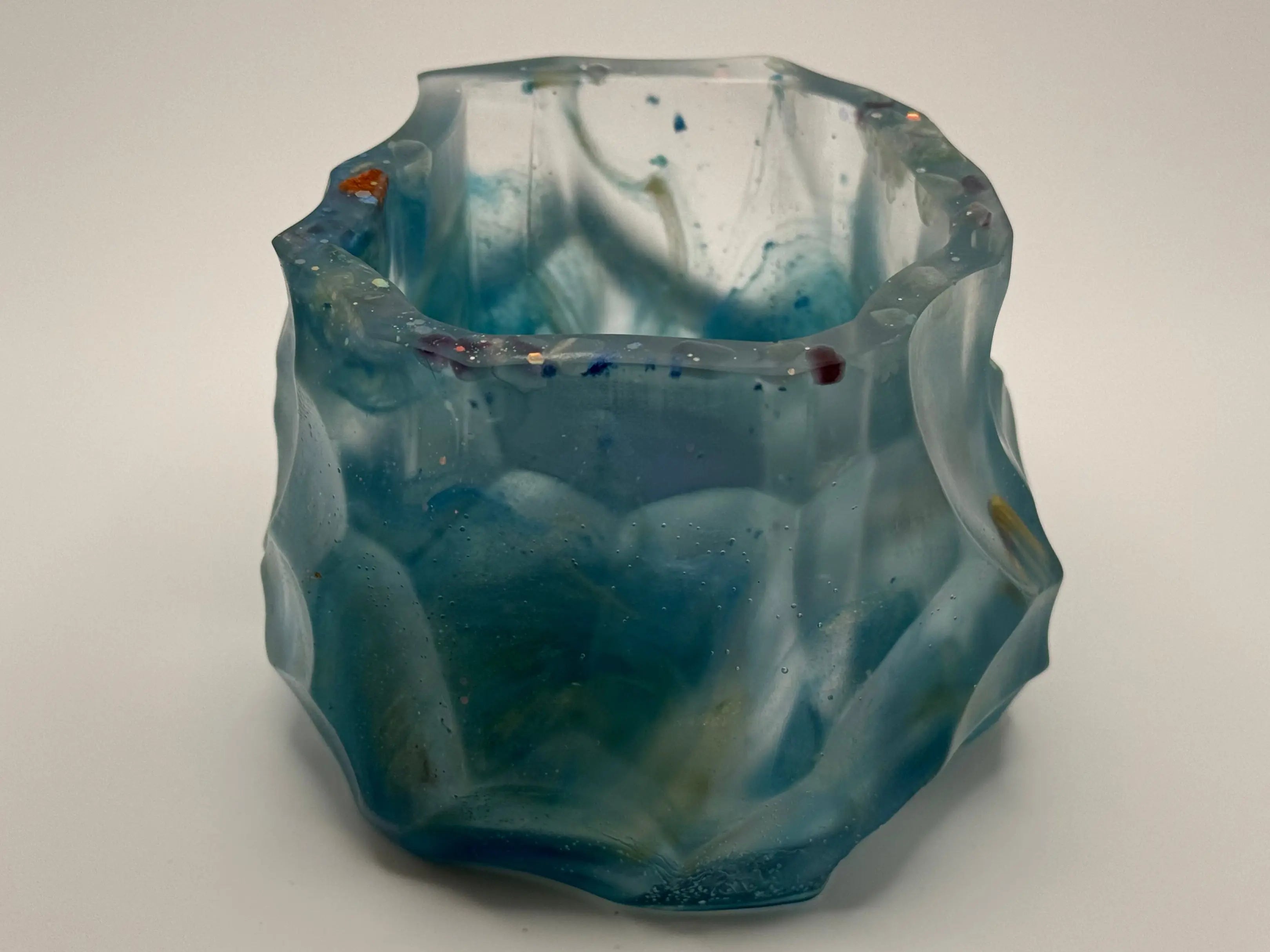 Octagon blue resin vase with textured surface on a white background