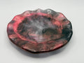 Decorative resin tray with florescent pink and black marbled pattern on a white background