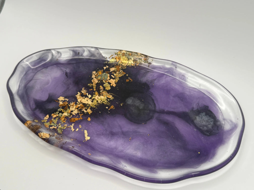 Purple resin dish with gold leaf on a white background