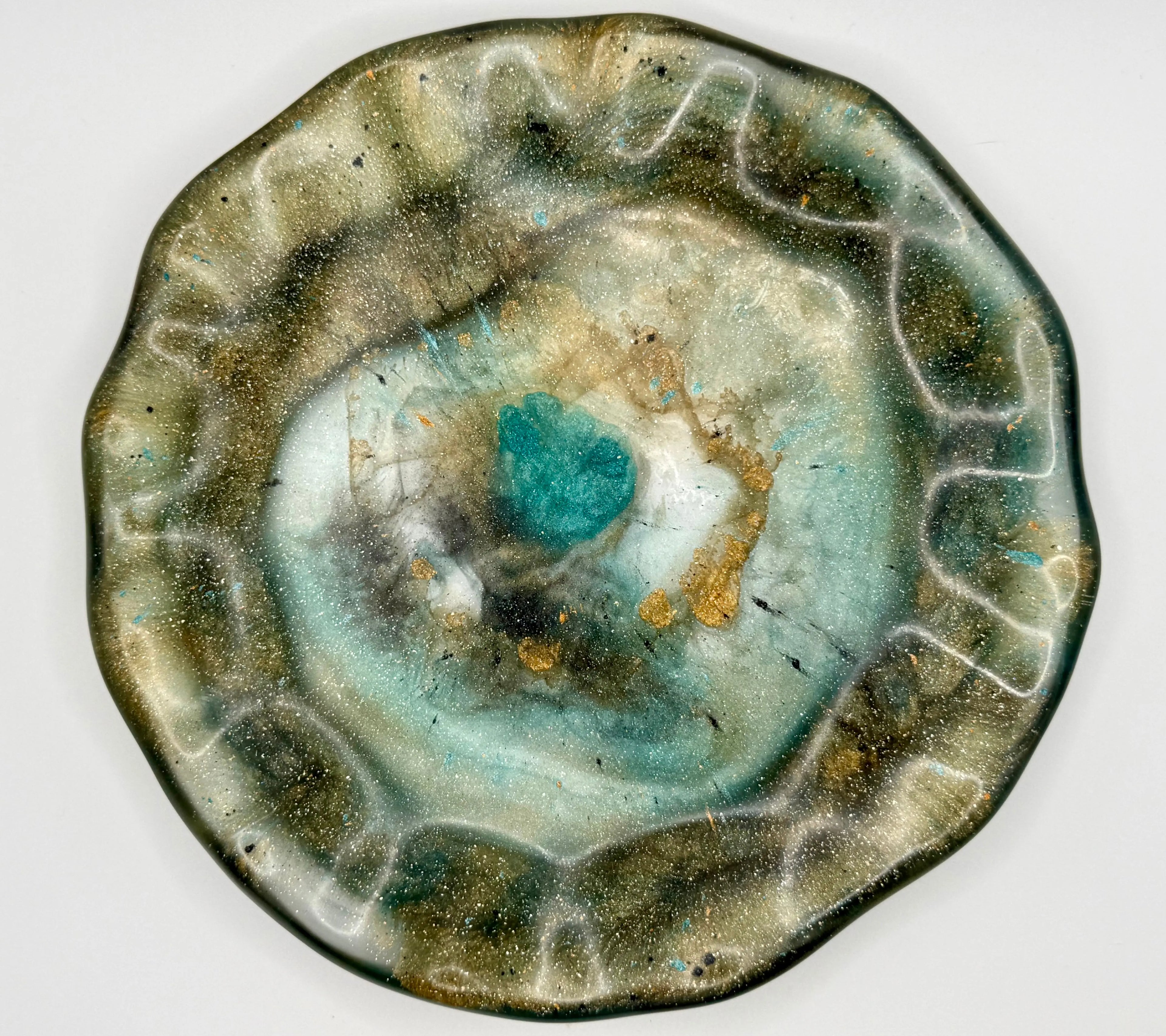 Earthy jeweled-toned resin free-form plate with organic design on a white background
